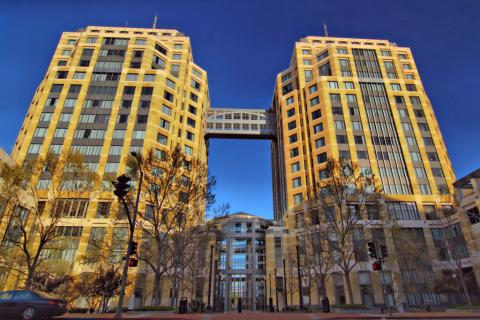 Oakland Regional Office has a beige exterior. It is a modern building with large windows and an American flag displayed prominently at the entrance.